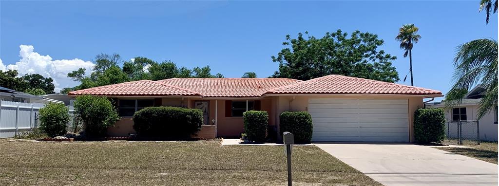 A single-story house with a terracotta tile roof and a two-car garage — 8024 JASMINE BOULEVARD, PORT RICHEY, FL
