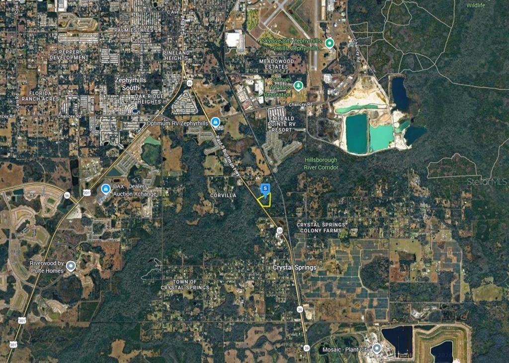 An aerial map view showing a highlighted property lot located along a highway — 2550 PAUL S BUCHMAN HIGHWAY, ZEPHYRHILLS, FL