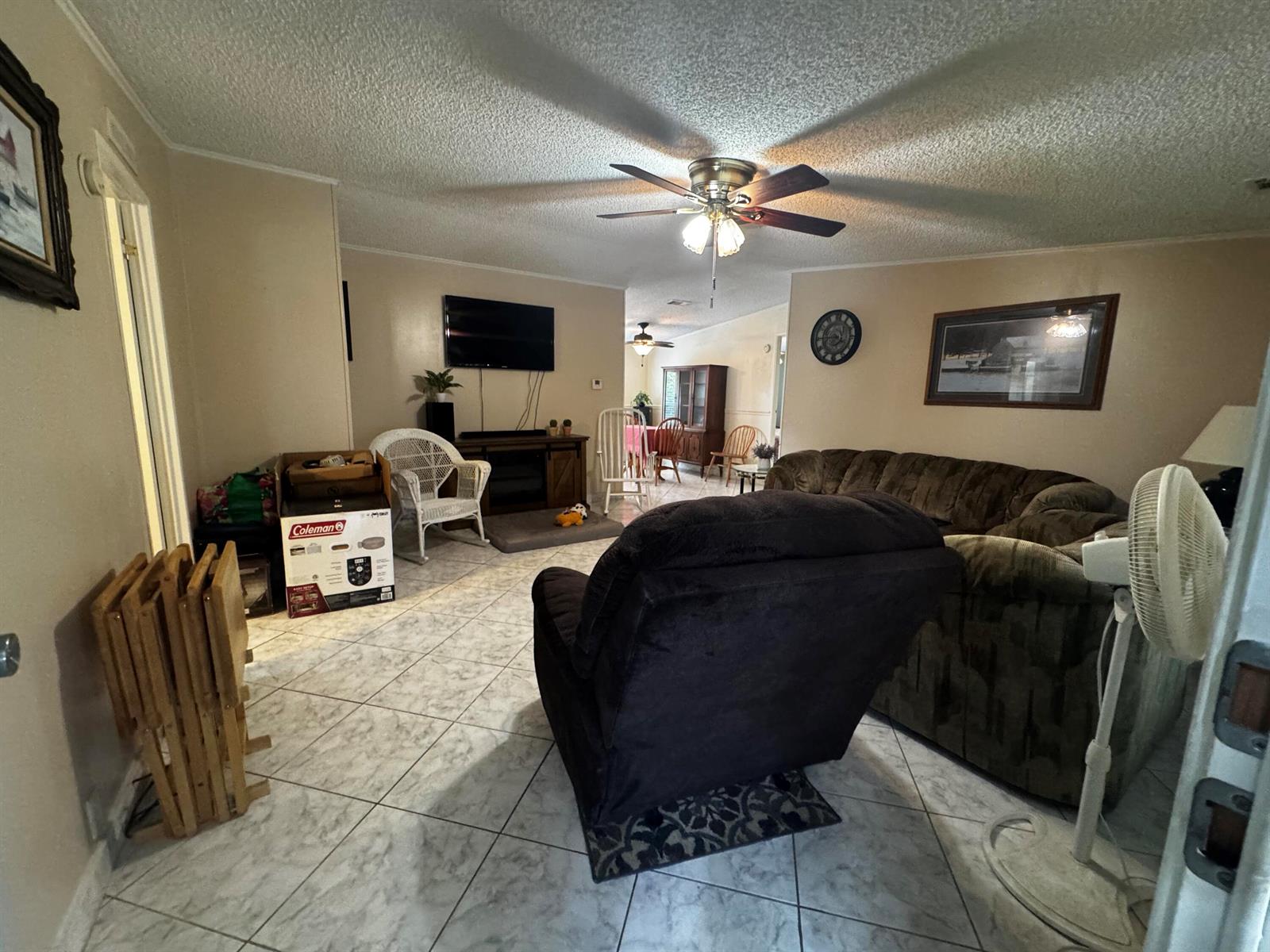 A living room features a ceiling fan, tiled floors, a recliner, and a sofa — 4081 4th Court, Lantana FL 33462, LANTANA, FL