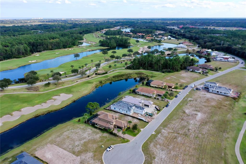 An aerial view shows houses under construction along a road next to a golf course — 355 HIBISCUS WAY, PALM COAST, FL