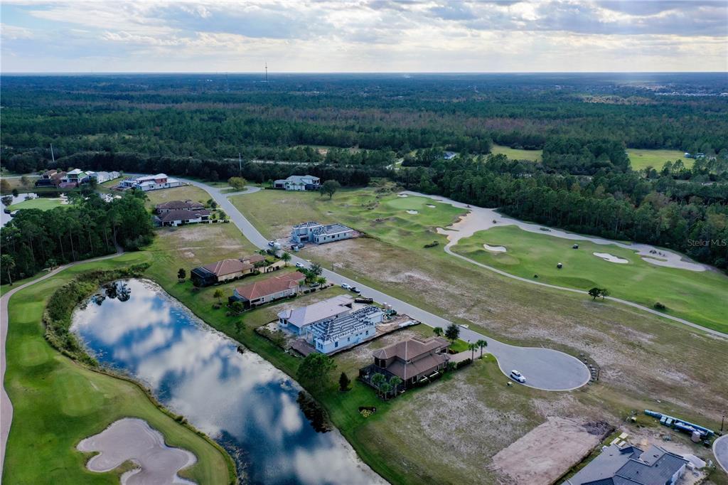 An aerial view shows a residential street with several houses under construction near a golf course — 355 HIBISCUS WAY, PALM COAST, FL
