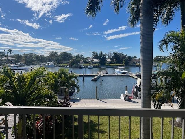 A view of a boat marina from a balcony with a railing and palm trees — 7150 N TAMIAMI TRAIL UNIT C233, SARASOTA, FL