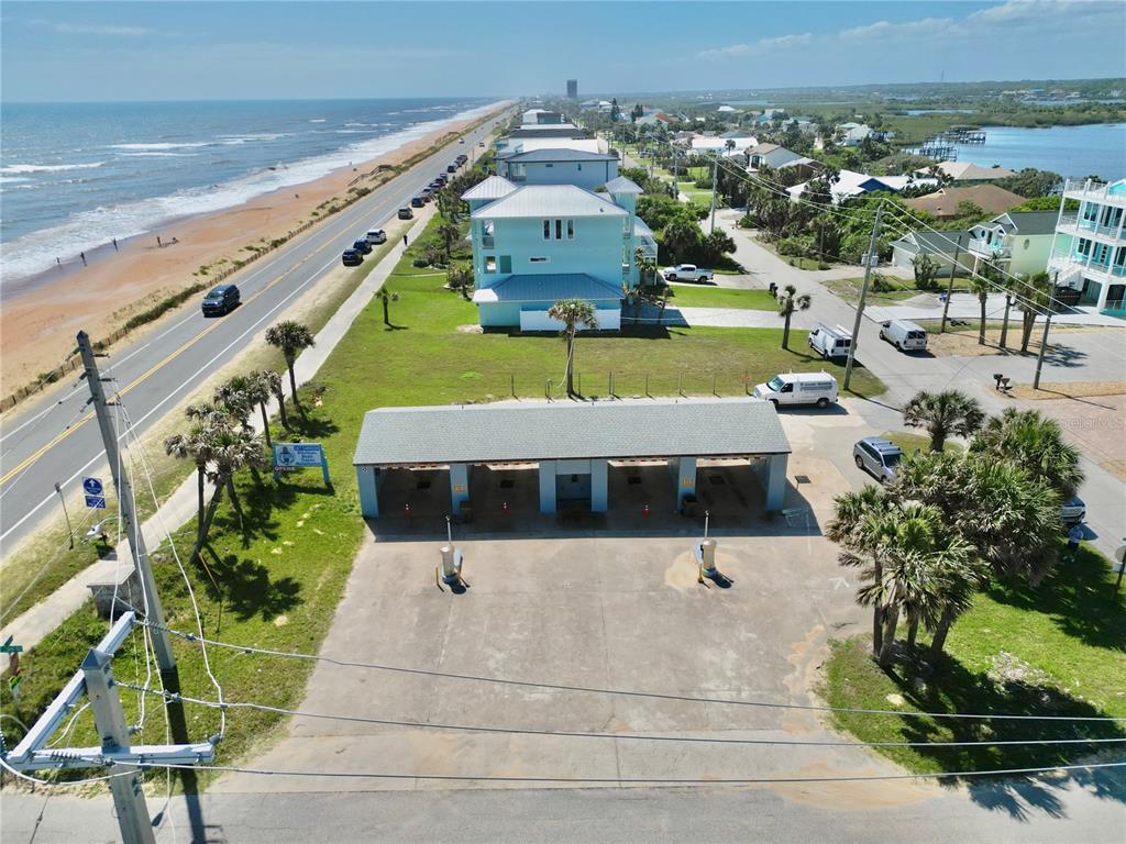 An aerial view shows a car wash facility located near a beach and coastal road — 2299 N OCEANSHORE BOULEVARD, FLAGLER BEACH, FL