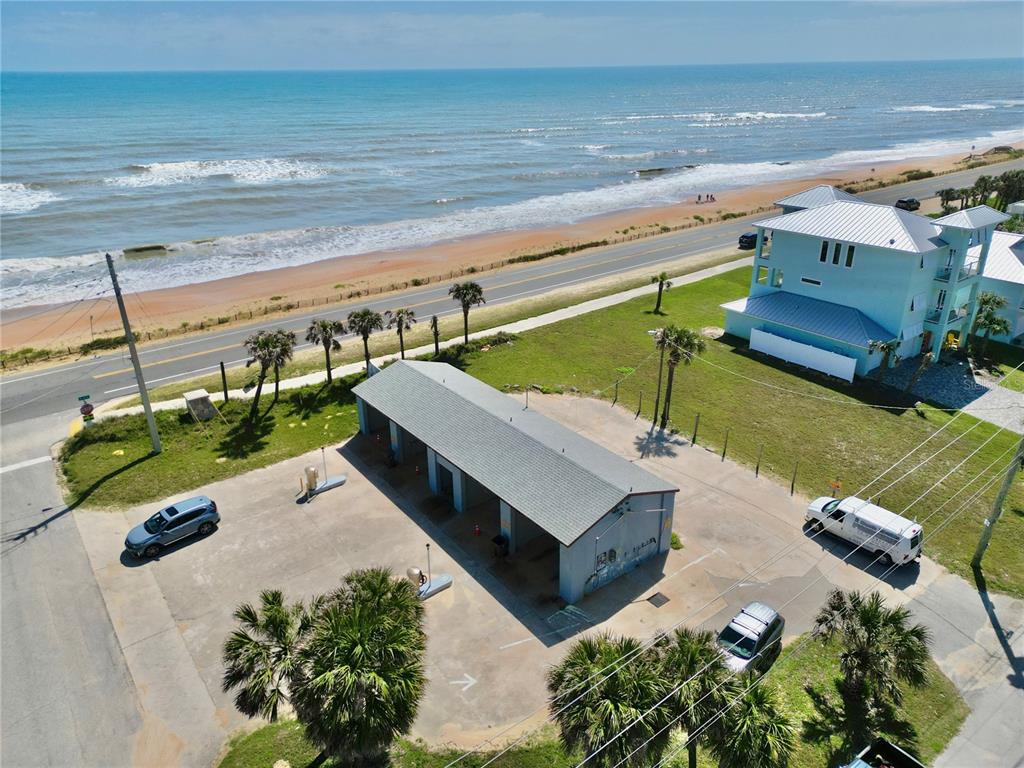 An aerial view shows a car wash facility located near a beach and coastal road — 2299 N OCEANSHORE BOULEVARD, FLAGLER BEACH, FL