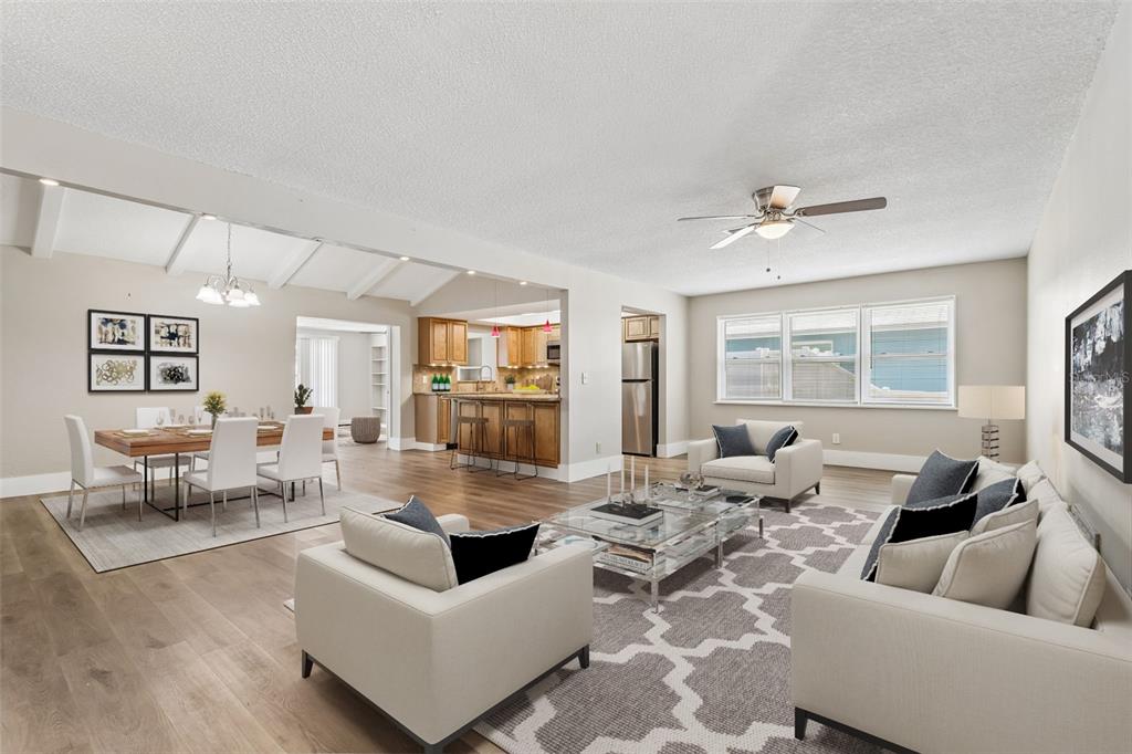 A kitchen features wood cabinets, granite countertops, stainless steel appliances, and recessed ceiling lighting — 13691 SERENA DRIVE, LARGO, FL