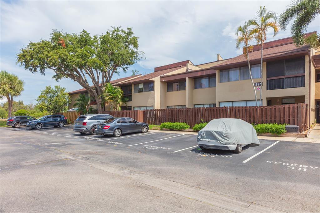 A multi-story apartment building with a parking lot in the foreground — 895 N VILLAGE DRIVE N UNIT 204, ST PETERSBURG, FL