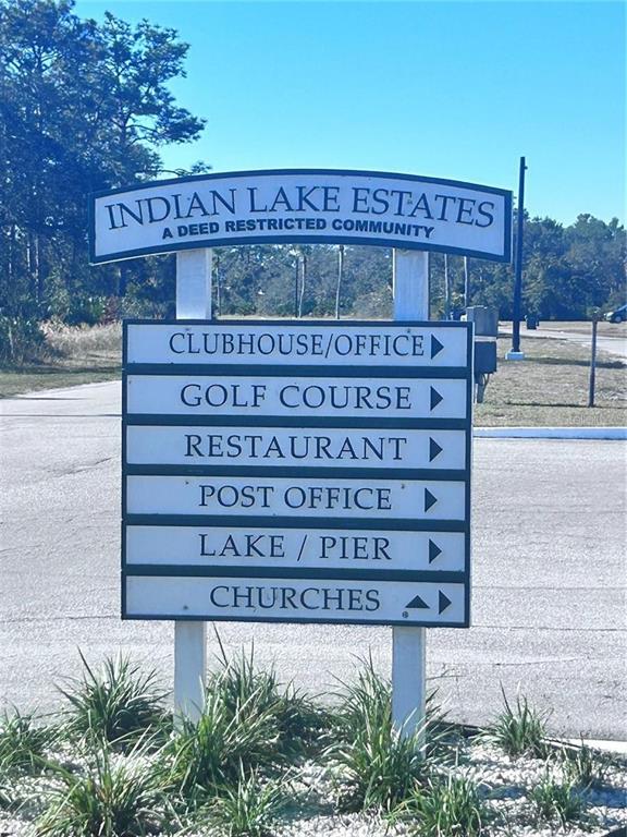 A sign for Indian Lake Estates lists directions to community amenities on a sunny day — 207 GARDENIA DRIVE, LAKE WALES, FL
