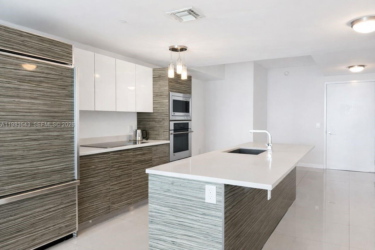 A balcony with glass railings overlooks a city skyline with several high-rise buildings — 460 NE 28th St # 1407, Miami FL 33137, MIAMI, FL