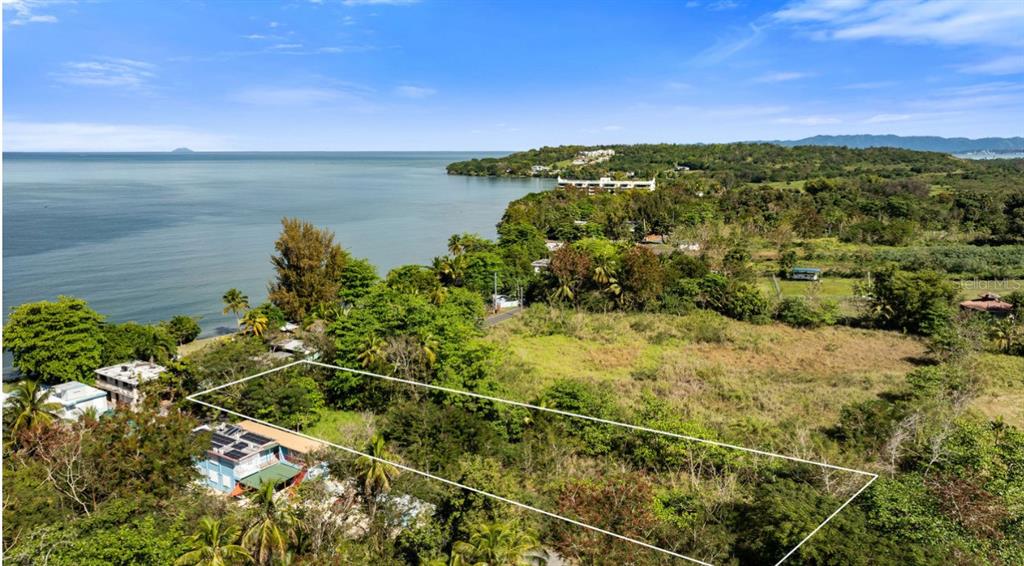 An aerial view shows a rectangular plot of land near a coastline with trees — Carr 102 KM.HM 10.3 BO. GUANAJIBO, SECTOR JOYUDA, CABO ROJO, PR