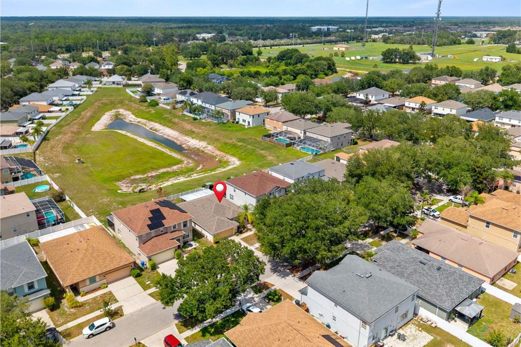 An aerial view shows a suburban neighborhood with a red pin marking a specific house — 13508 RED EAR COURT, RIVERVIEW, FL