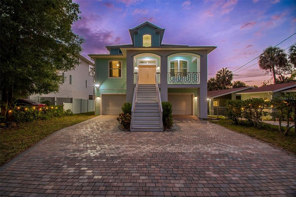 A two-story house with a paved driveway, elevated front entrance, and two garage doors — 6121 LAFAYETTE STREET, NEW PORT RICHEY, FL