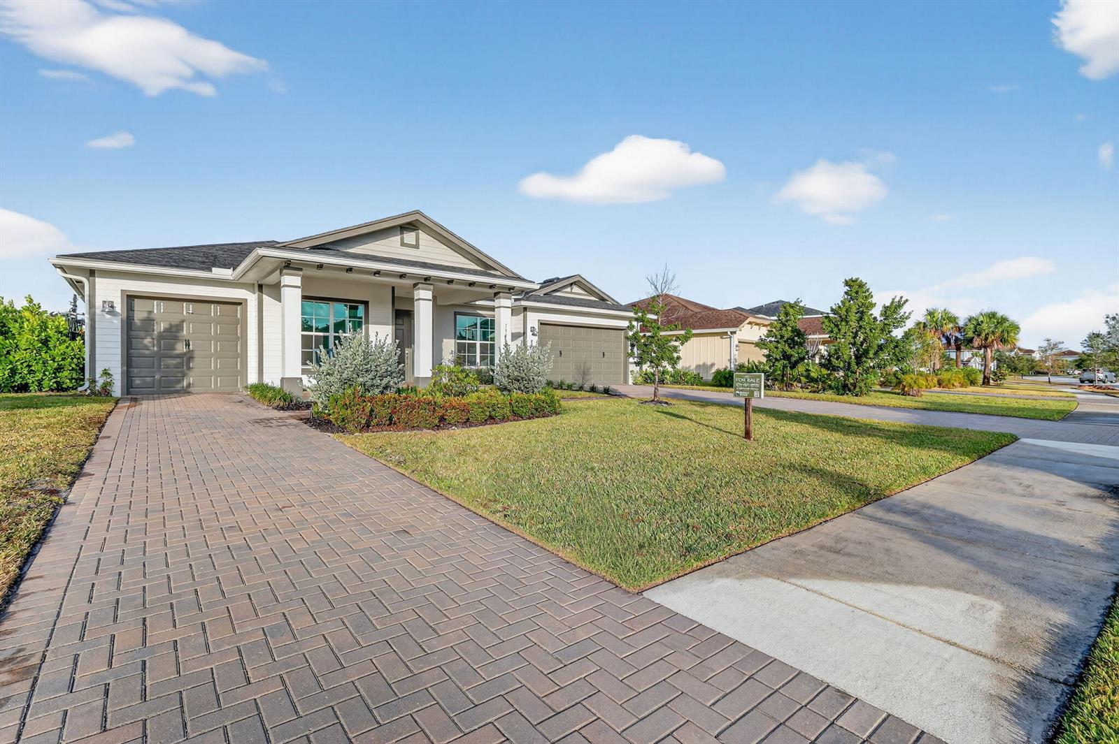 A single-story house with a brick paver driveway and a front-facing two-car garage — 799 Hookline Circle, Loxahatchee FL 33470, LOXAHATCHEE, FL