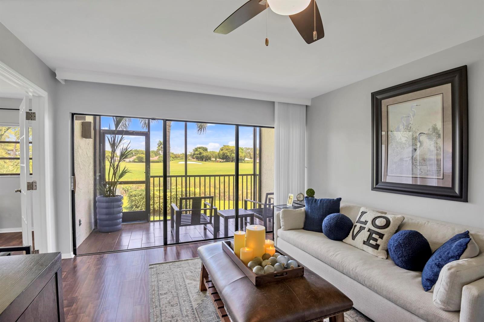 A kitchen features white cabinets, stainless steel appliances, and a gray-veined stone countertop — 401 Greensward Lane # a, Delray Beach FL 33445, DELRAY BEACH, FL