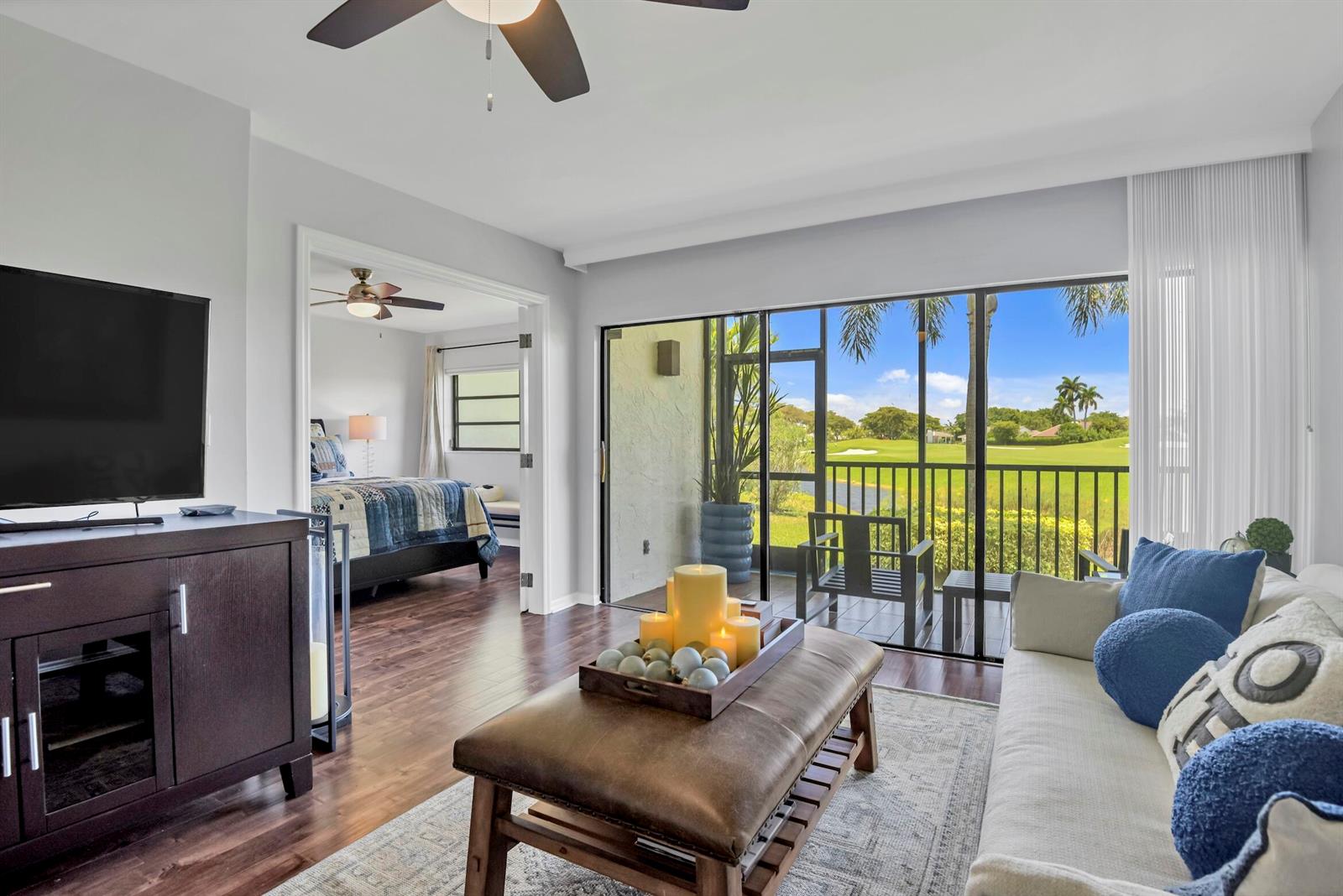 A modern kitchen features white cabinets, stainless steel appliances, and gray marble-patterned countertops — 401 Greensward Lane # a, Delray Beach FL 33445, DELRAY BEACH, FL
