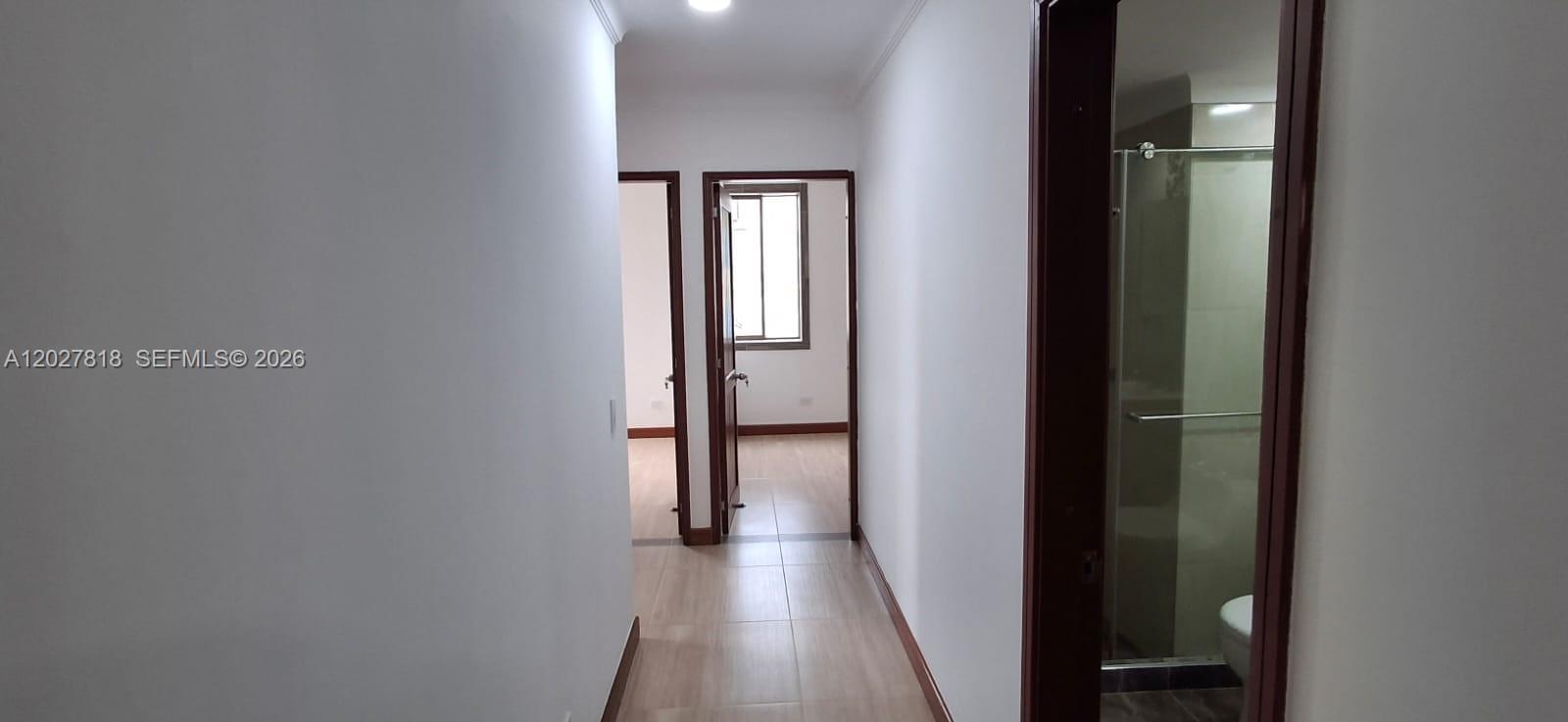 A hallway leads to a bedroom doorway with a bathroom visible on the right — Cra 15 4 28 # 401, 0, FL