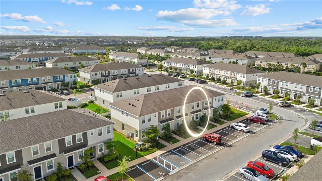 An aerial view shows a multi-story townhouse complex with a highlighted unit and parking — 8780 DAYBREAK STREET, SARASOTA, FL
