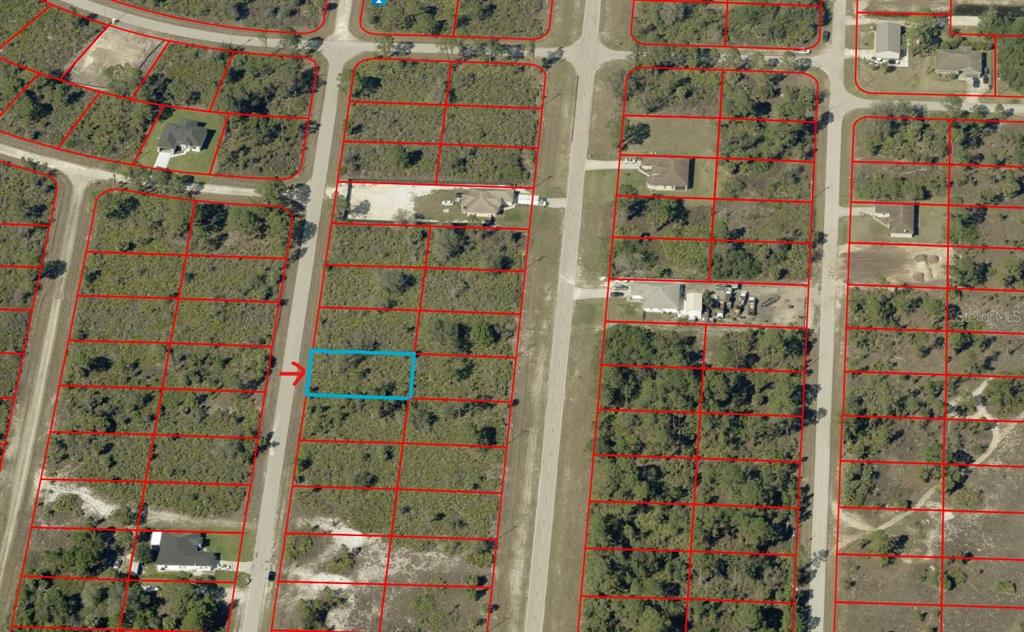 An aerial view shows a vacant rectangular lot highlighted in blue within a residential subdivision — 645 VALLEY AVENUE S, LEHIGH ACRES, FL