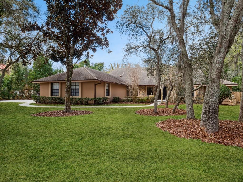 A single-story house with a tan exterior and stone accents sits behind a grassy yard — 5314 SHADYWOOD LANE, ORLANDO, FL