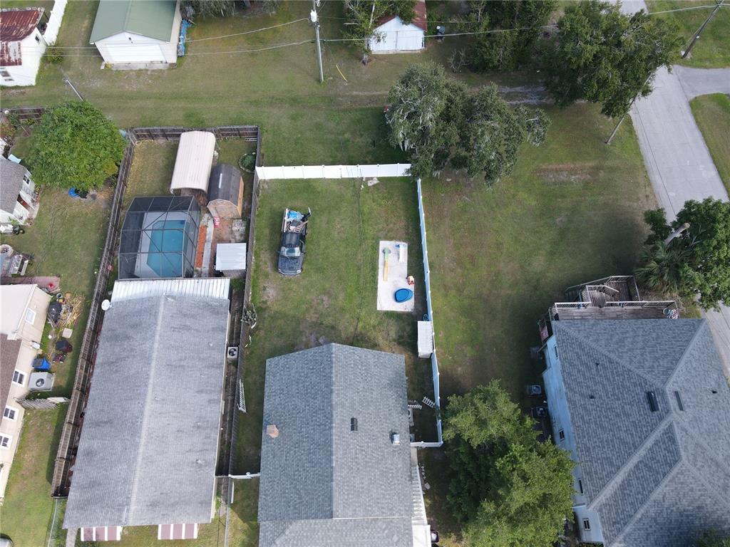 An aerial view shows a residential property with a house, pool, and fenced backyard — 817 OHIO AVENUE, ST CLOUD, FL