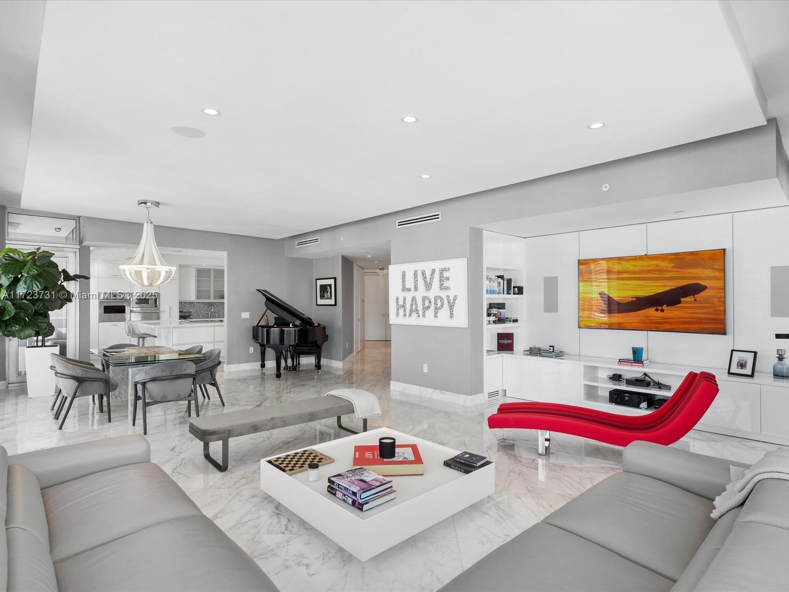 A modern living and dining area features marble floors, a grand piano, and a red chaise — 1425 Brickell Ave, Miami FL 33131, MIAMI, FL
