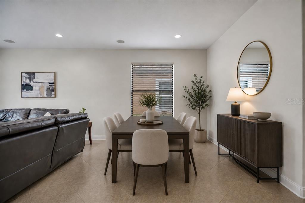 A dining area features a dark wood table with six chairs and a matching sideboard — 8013 HAMPTON GLEN DRIVE, TAMPA, FL