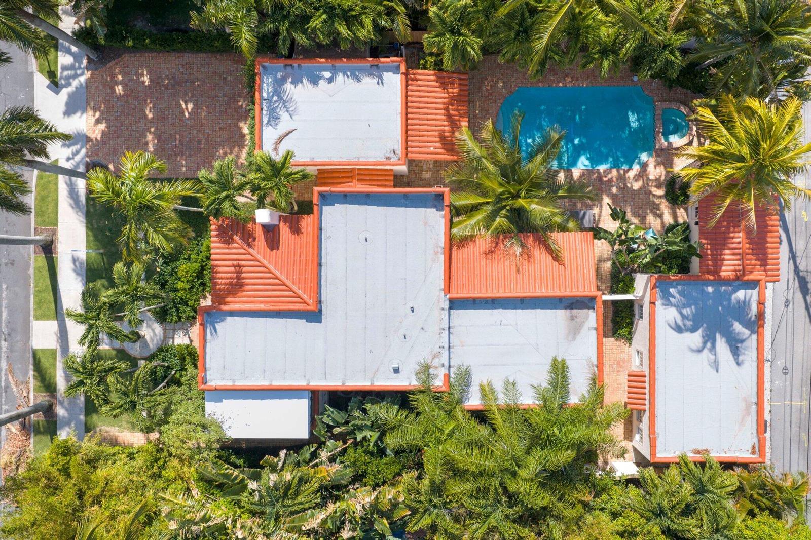 An aerial view of a house with a flat roof, red tile accents, and a pool — 429 30th Street, West Palm Beach FL 33407, WEST PALM BEACH, FL