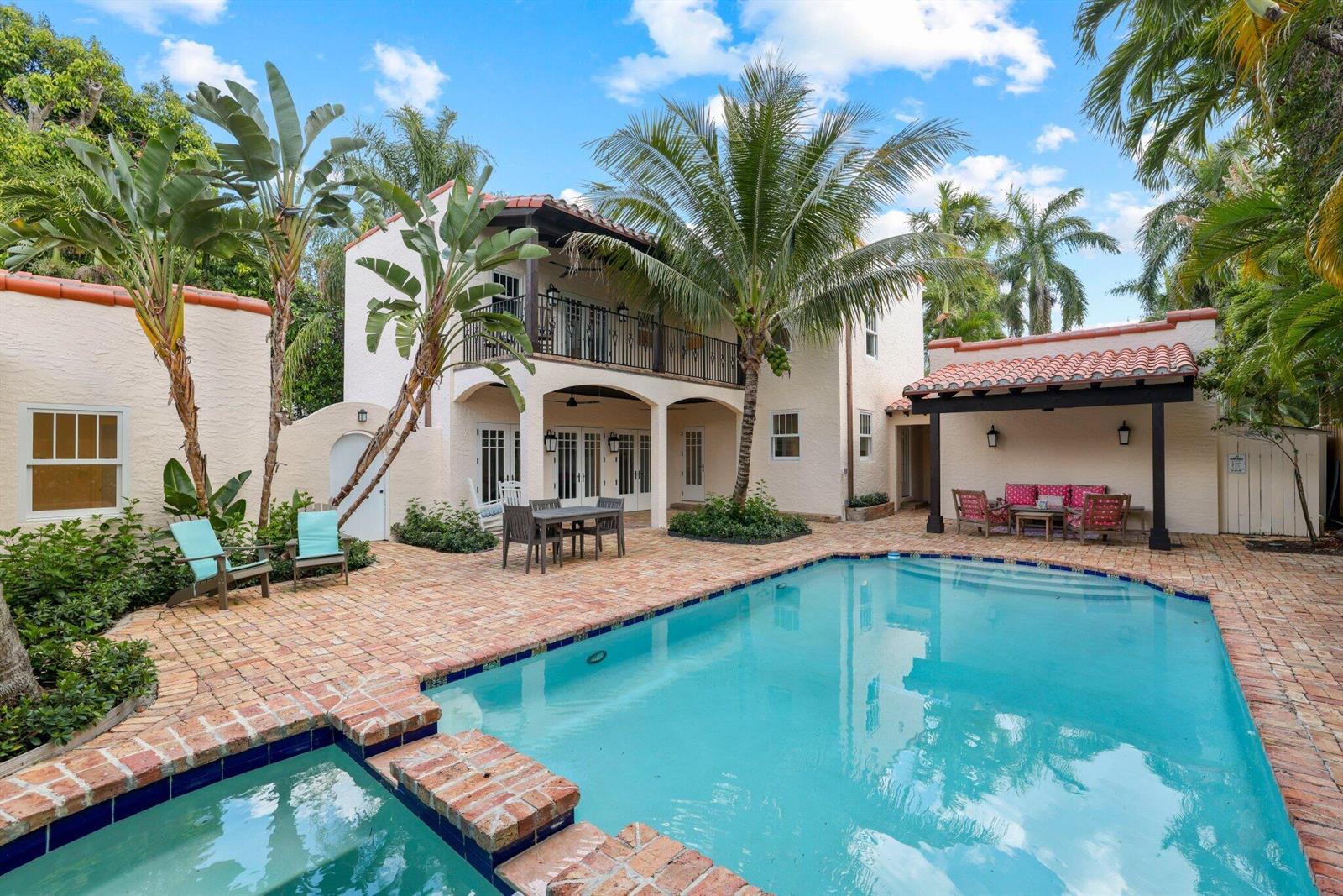 A backyard features a swimming pool, a brick patio, a covered seating area, and palm trees — 429 30th Street, West Palm Beach FL 33407, WEST PALM BEACH, FL