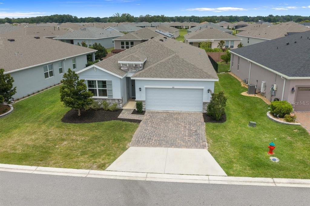 An aerial view shows a single-story suburban house with a paved driveway and green lawn — 4313 NW 55TH COURT, OCALA, FL