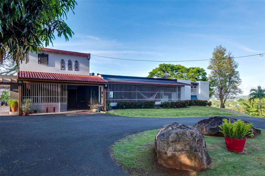 A single-story house with a tiled roof, metal security bars, and a large front driveway — Bo Cerro Gordo, Carr 840 SECTOR VILLAS DEL OLIMPO, BAYAMON, PR