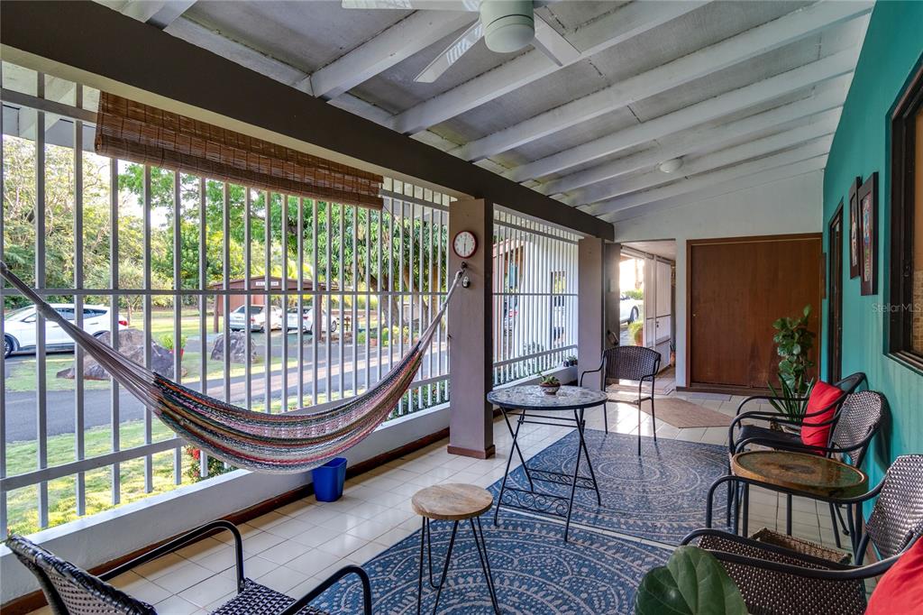 A covered patio features a hammock, outdoor seating, a round table, and a tiled floor — Bo Cerro Gordo, Carr 840 SECTOR VILLAS DEL OLIMPO, BAYAMON, PR