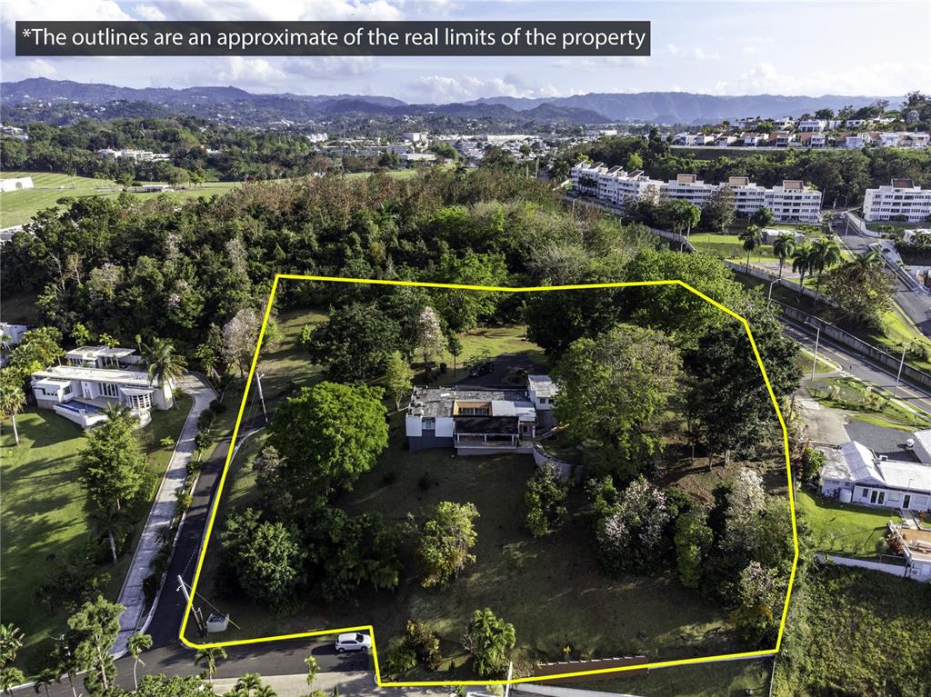An aerial view shows a house situated on a large, tree-filled lot with yellow boundary lines — Bo Cerro Gordo, Carr 840 SECTOR VILLAS DEL OLIMPO, BAYAMON, PR