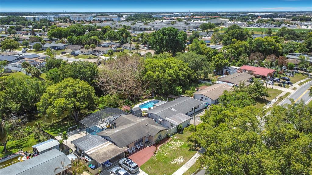 An aerial view shows a residential house with a screened pool and a carport — 7511 BROCKBANK DRIVE, ORLANDO, FL