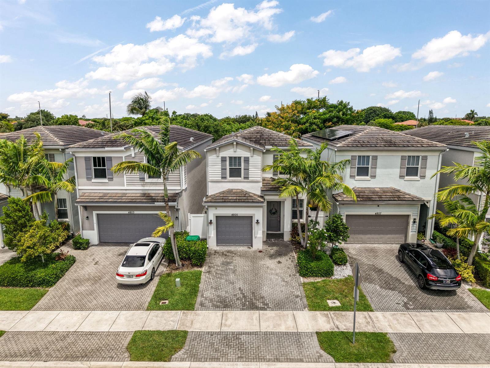 An aerial view shows three two-story suburban houses with paved driveways and palm trees — 4805 NW 48th Terrace, Tamarac FL 33319, TAMARAC, FL