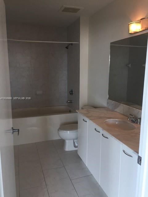 An unfurnished living area features a concrete ceiling, polished concrete floors, and large glass balcony doors — 133 NE 2nd Ave # 913, Miami FL 33132, MIAMI, FL