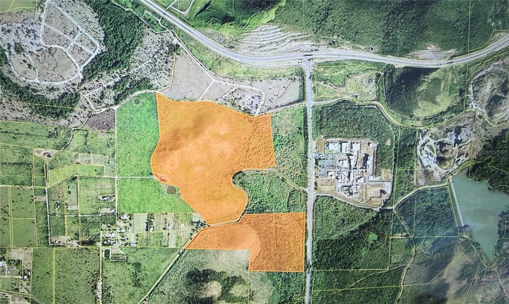 An aerial map shows two highlighted orange parcels of land divided by a north-south road — POZO HONDO, GUAYAMA, PR