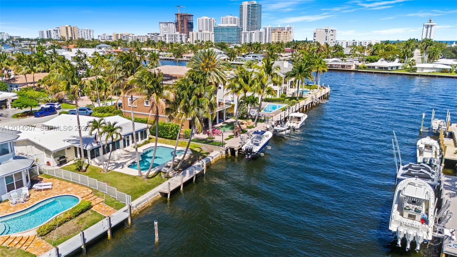 An aerial view shows waterfront homes with swimming pools and docked boats along a canal — 2548 SE 12th St, Pompano Beach FL 33062, POMPANO BEACH, FL