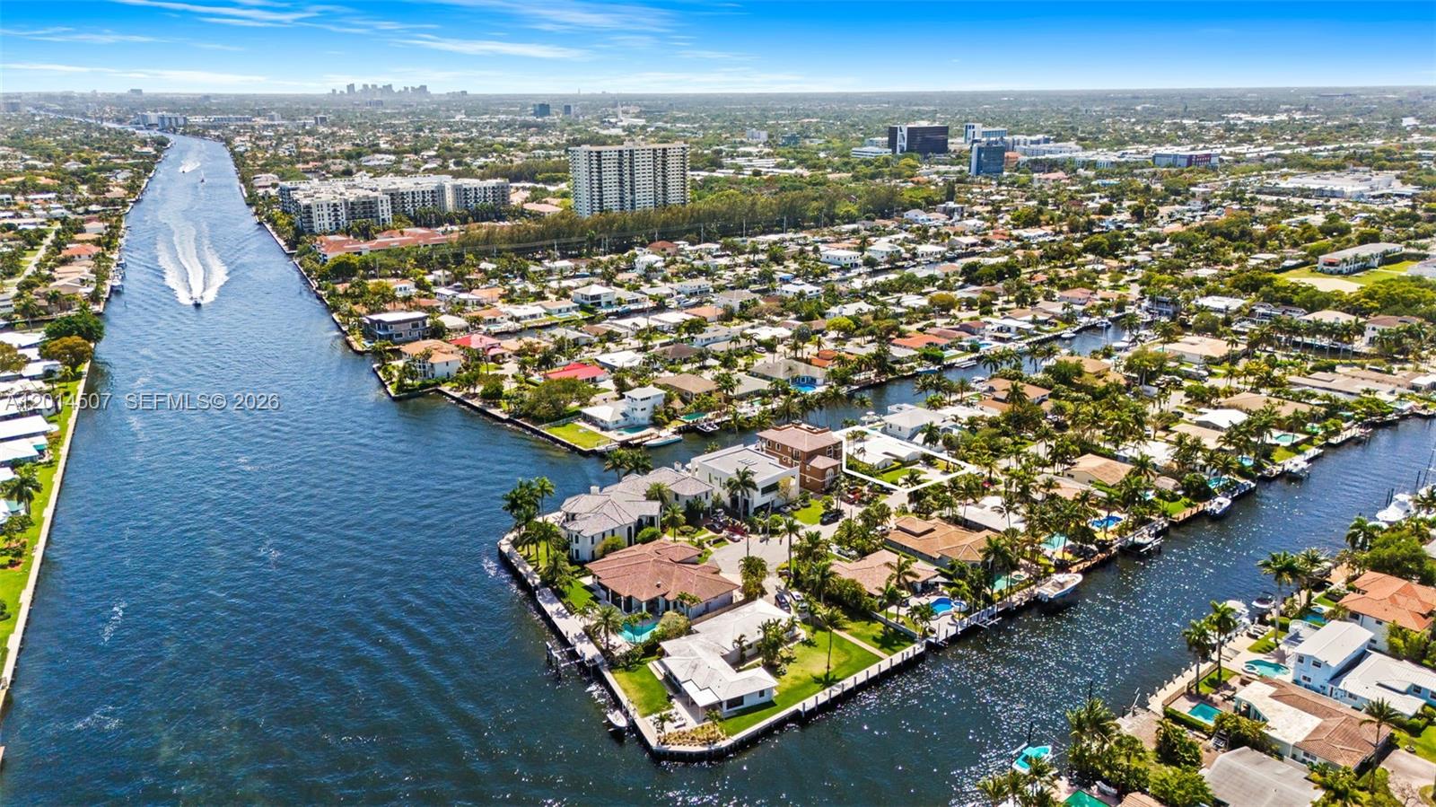 An aerial view shows waterfront homes along a canal with boats and lush landscaping — 2548 SE 12th St, Pompano Beach FL 33062, POMPANO BEACH, FL