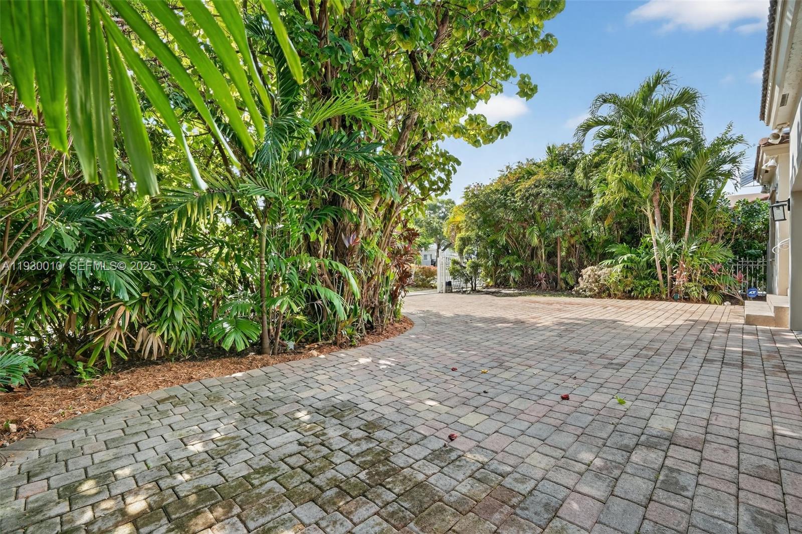 A two-story white house with a paved driveway, arched entryway, and gated front yard — 2913 SW 13th St, Miami FL 33145, MIAMI, FL
