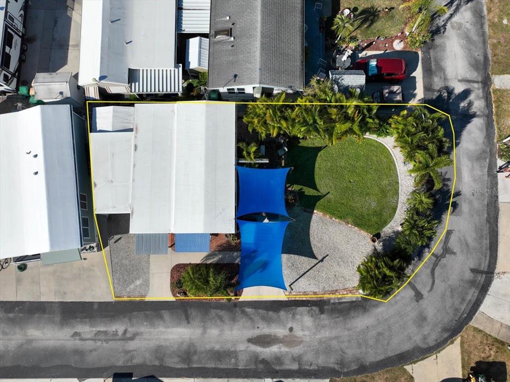 An aerial view shows a residential lot with a house, blue shade sails, and landscaping — 1475 FLAMINGO DRIVE UNIT 346, ENGLEWOOD, FL