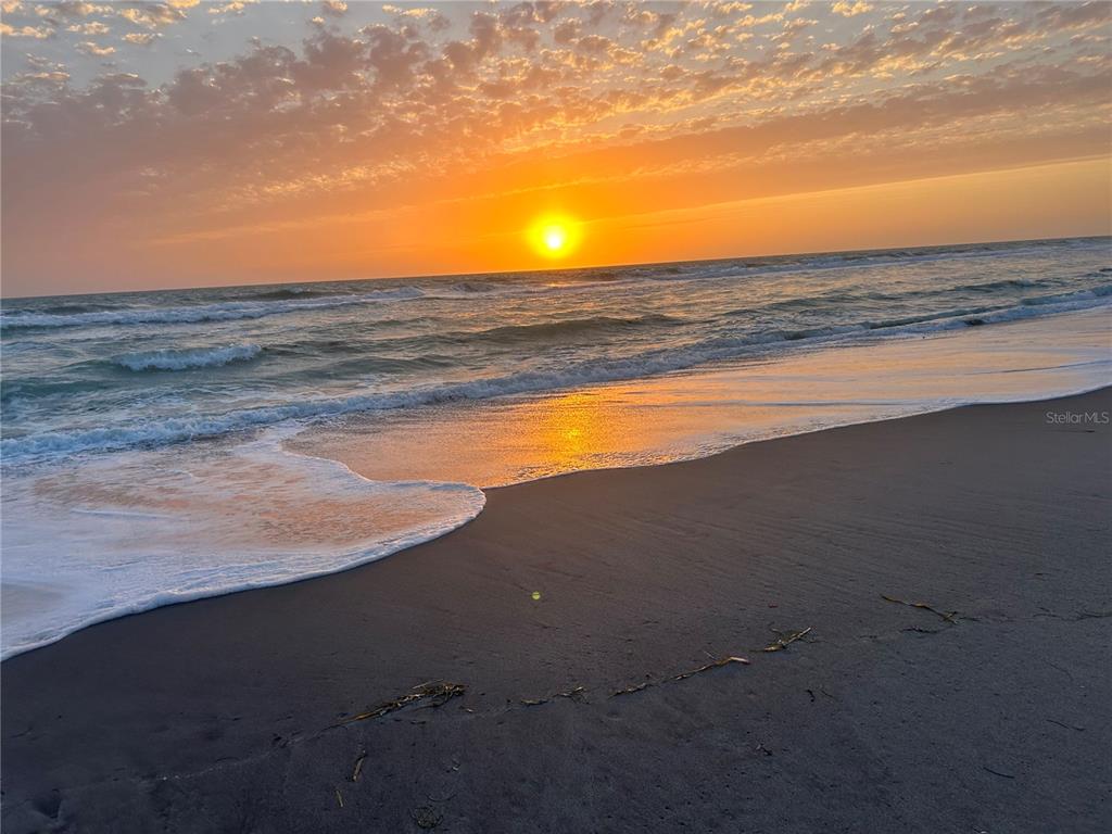 A sunset view over the ocean waves washing onto a sandy beach — 2450 ALAMANDER AVENUE, ENGLEWOOD, FL