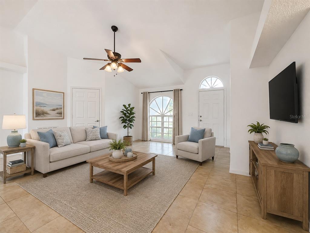 A living room features a beige sofa, armchair, wooden coffee table, and tile flooring — 6146 104TH AVENUE N, PINELLAS PARK, FL