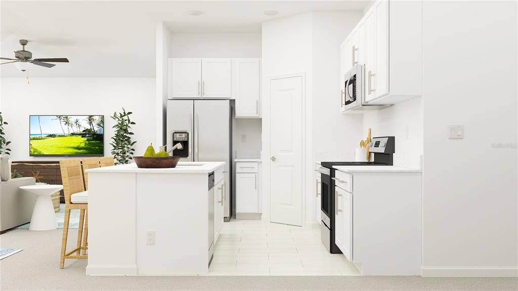 A modern kitchen features white cabinetry, stainless steel appliances, and a central island with seating — 3821 NORTHERN KEY DRIVE, PLANT CITY, FL