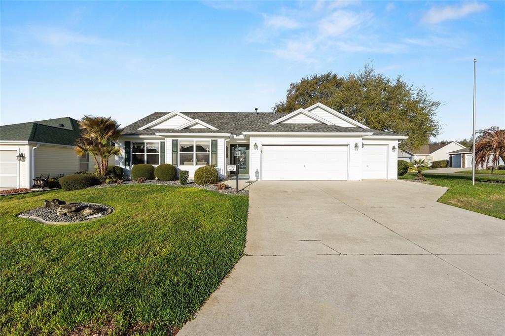 A single-story white house with a two-car garage and a concrete driveway — 624 FAYETTE COURT, THE VILLAGES, FL
