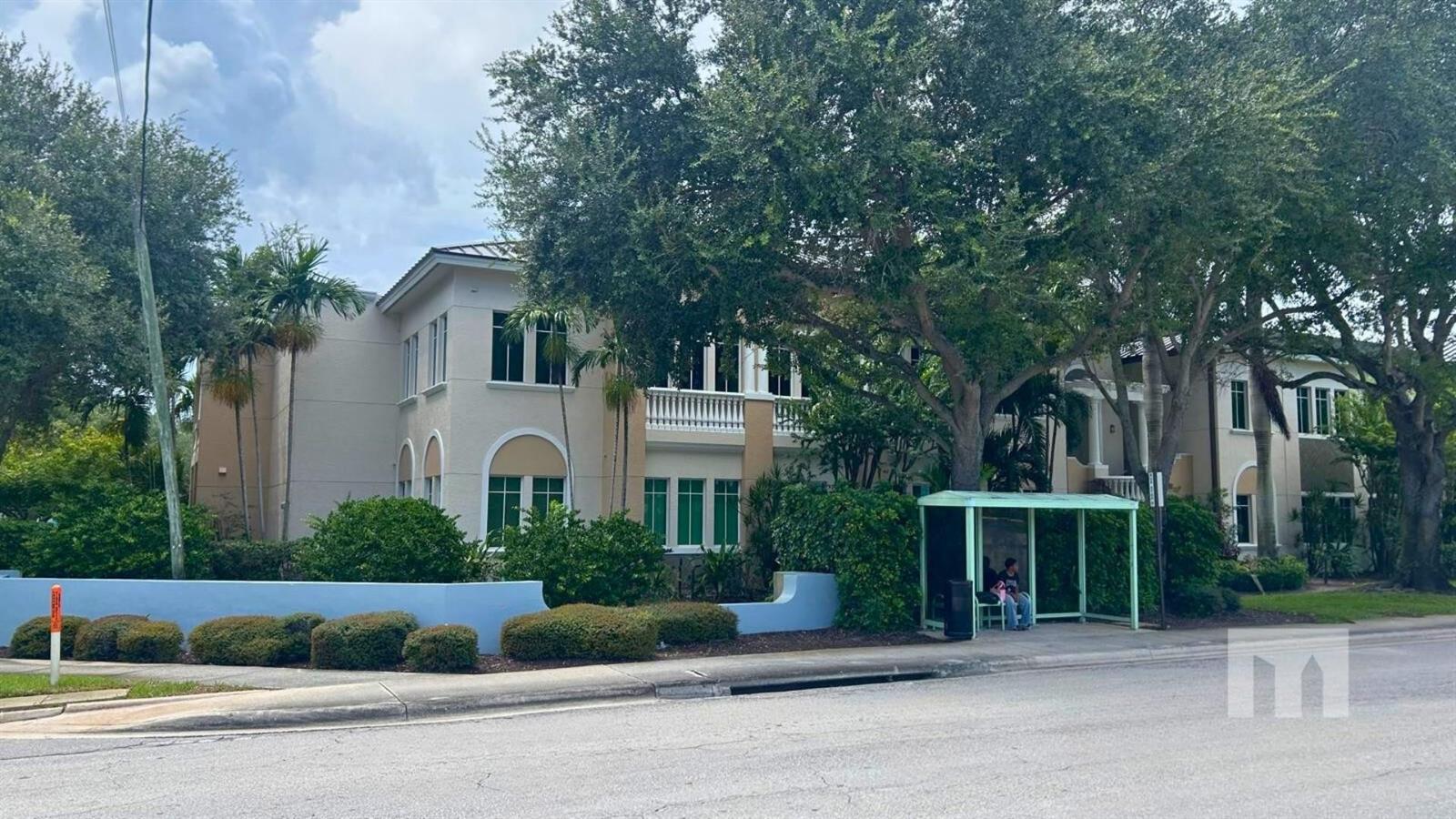 A multi-story apartment building with a bus stop shelter in front — 160 Congress Park Drive # 111, Delray Beach FL 33445, DELRAY BEACH, FL