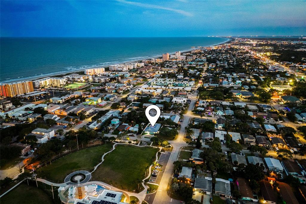 An aerial view shows a residential neighborhood near a beach with a location marker — 303 HARRISON AVENUE, CAPE CANAVERAL, FL