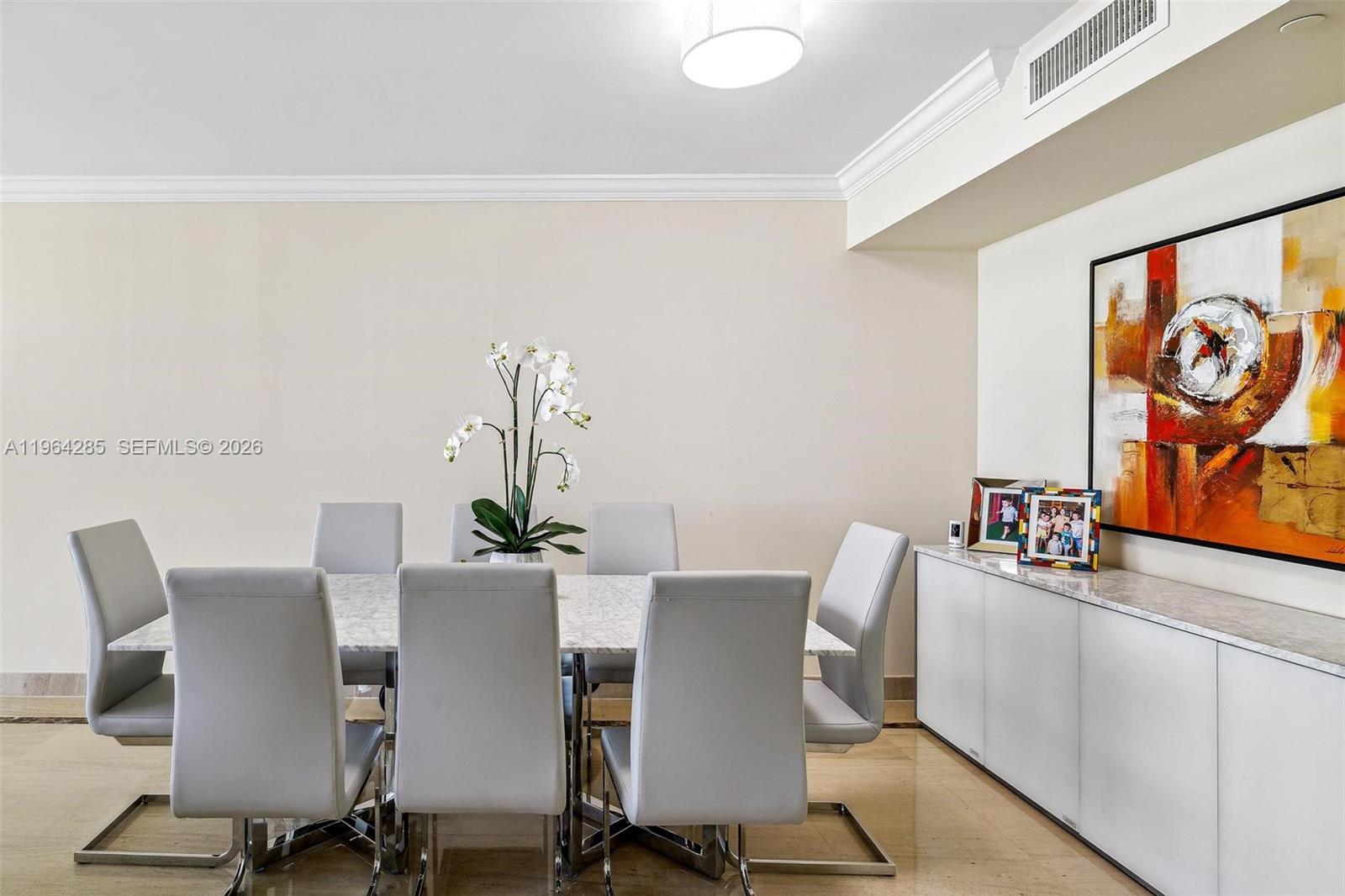 A dining room features a marble-topped table, six gray chairs, and a white sideboard — 1800 S Ocean Dr # 1010, Hallandale Beach FL 33009, HALLANDALE BEACH, FL