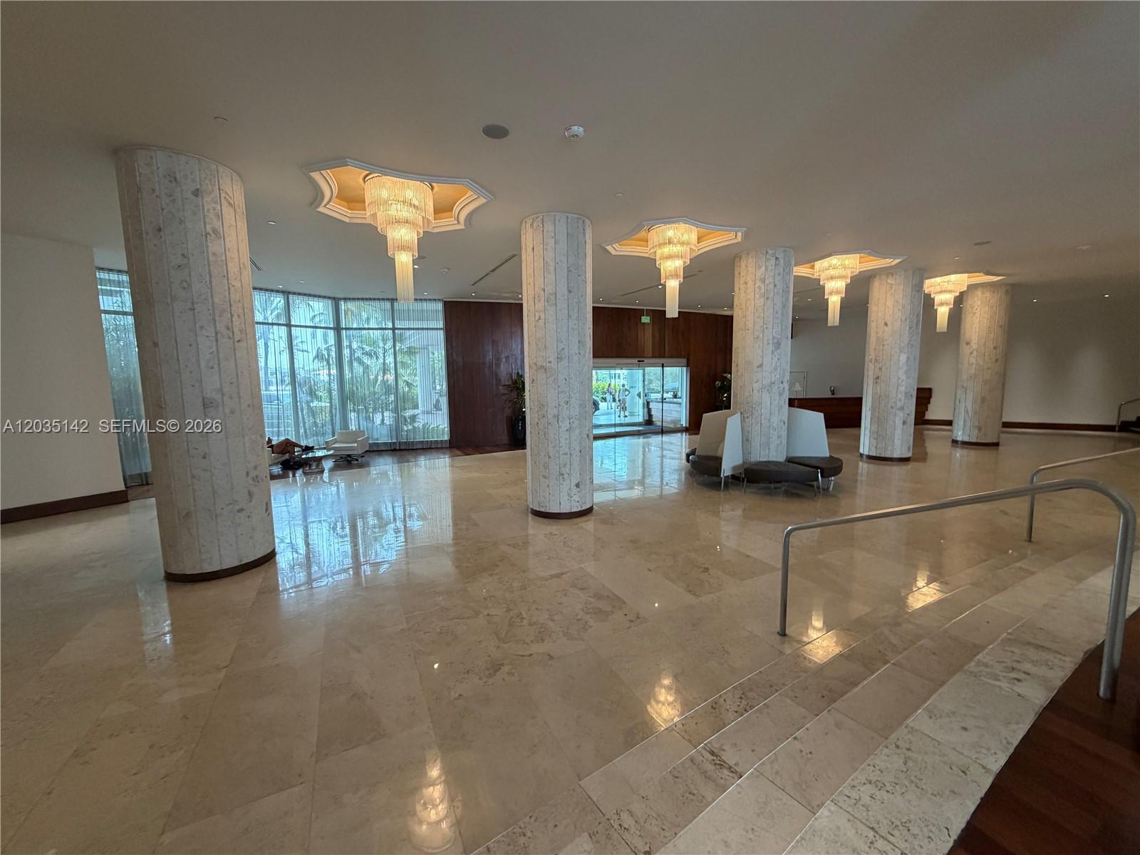A spacious lobby features marble floors, large stone columns, and tiered chandeliers — 5161 Collins Ave # 310, Miami Beach FL 33140, MIAMI BEACH, FL