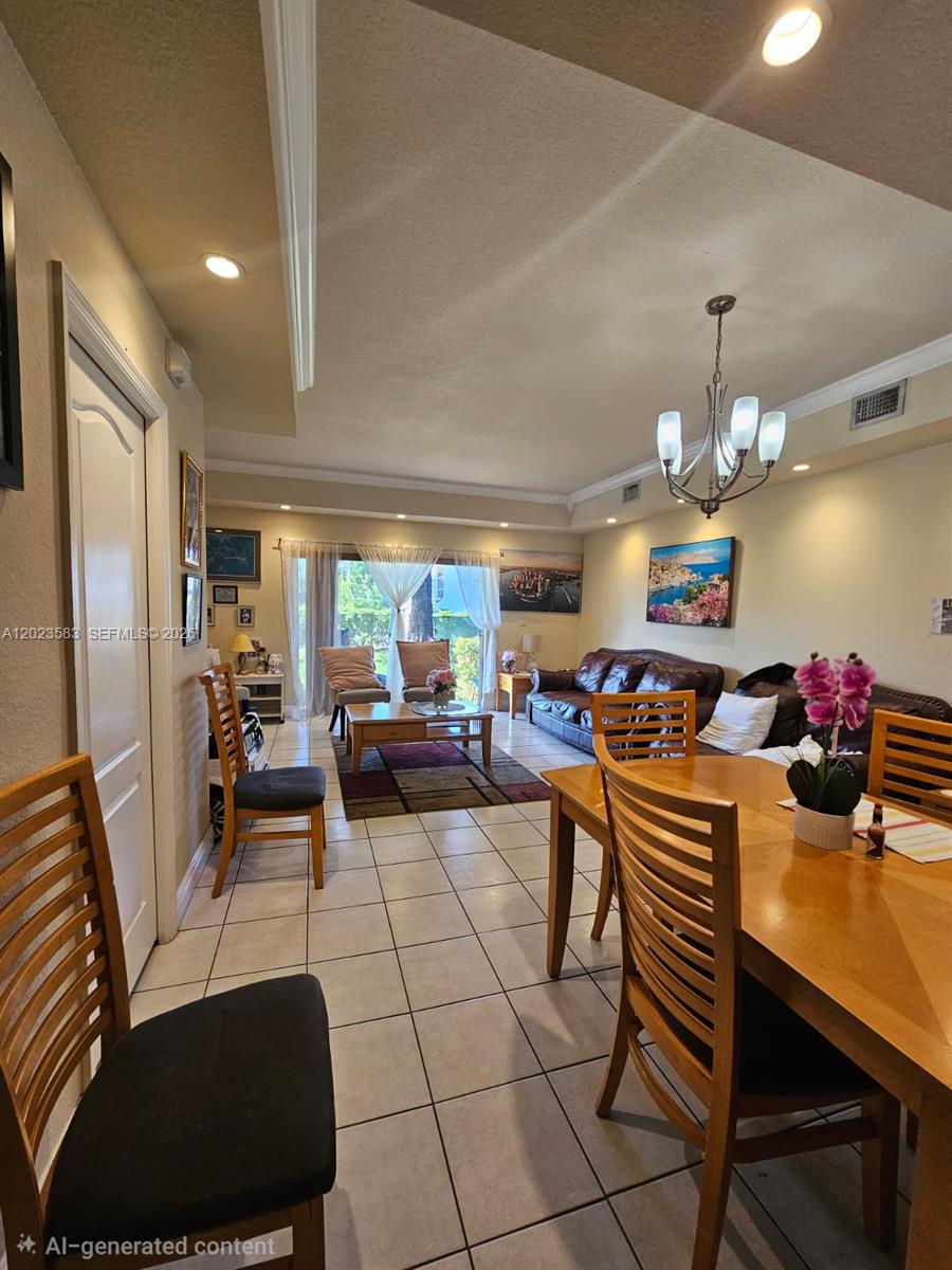 A dining area and living room with tile floors, wooden furniture, and a chandelier — 8960 W Flagler St # 3, Miami FL 33174, MIAMI, FL