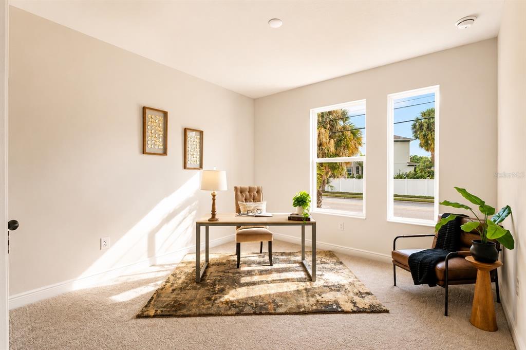 A home office features a desk, chair, leather armchair, area rug, and two large windows — 4614 W EUCLID AVENUE, TAMPA, FL