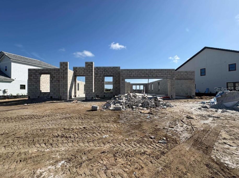 A construction site shows the concrete block walls of a house under development — 10645 SPRING SAPLING CIRCLE, PARRISH, FL